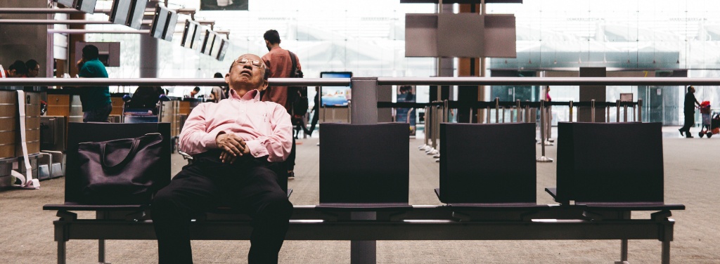 man sleeping at airport