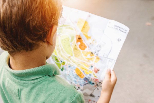 small child looking at a map