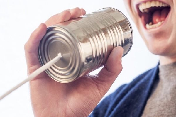 Man talking through a can