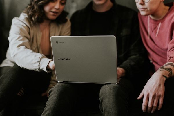 People sharing a laptop